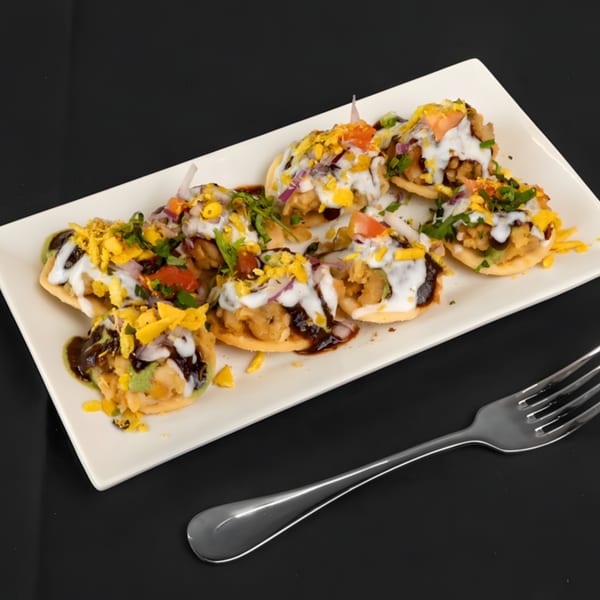 Zaika Indian Bistro Bar's papri chaat, crispy flatbreads topped with potatoes, yogurt, chutneys, and spices.